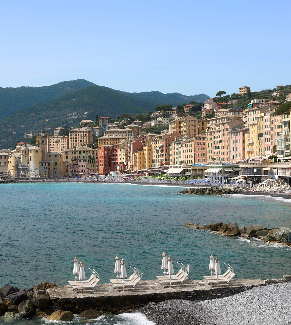 Hotel beach loungers with the colourful houses of Camogli in the background